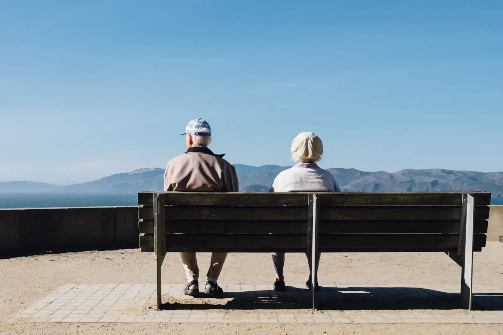 Older couple on a bench by the sea