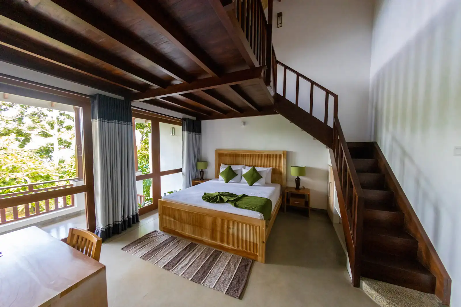 Villa bedroom with a timber staircase