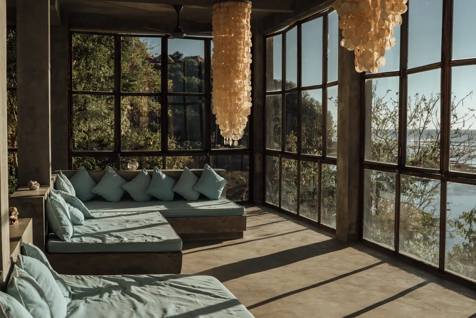 Living room with windows onto the jungle
