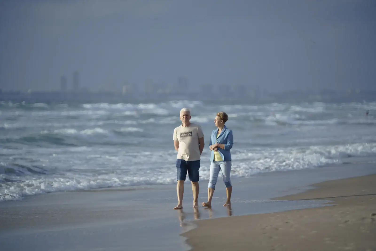 Older couple walking on the beach